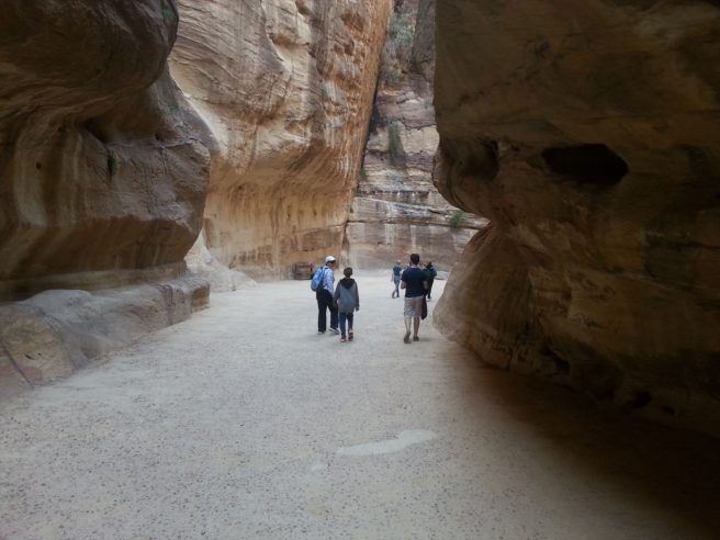 People walking through the narrow Siq