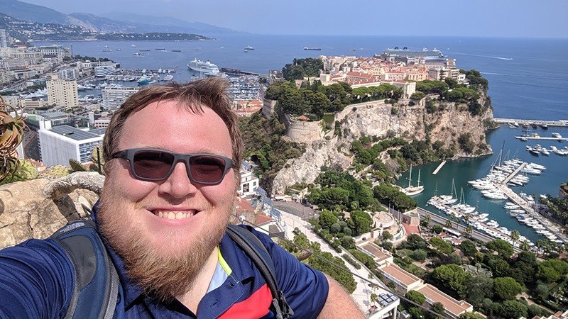 Dr. McCubbin posing with a coastal view while geocaching,